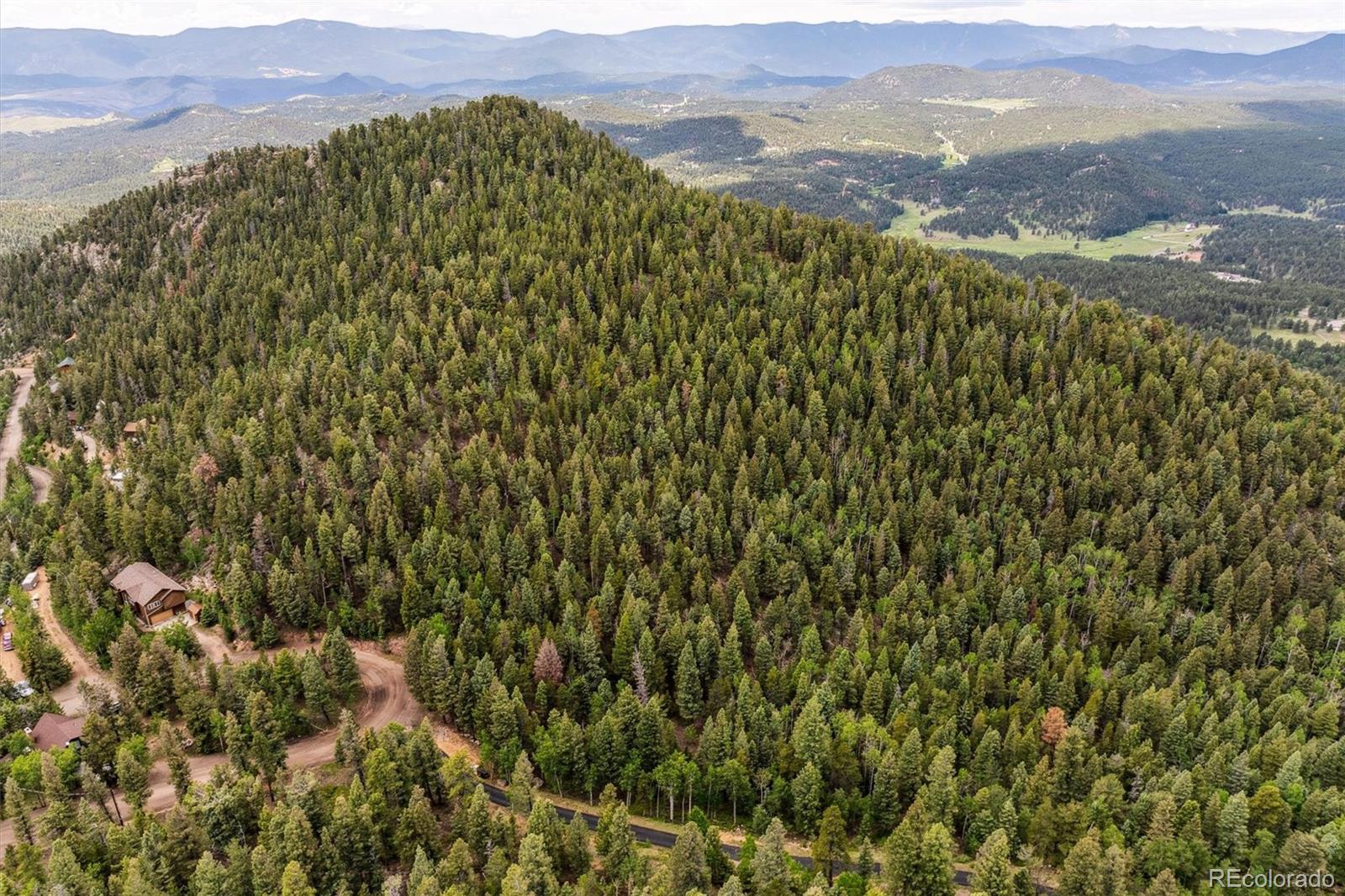 31545 Pike View Drive Conifer, CO 80433 - Photo 18 of 21 a view of a lush green field with mountains in the background