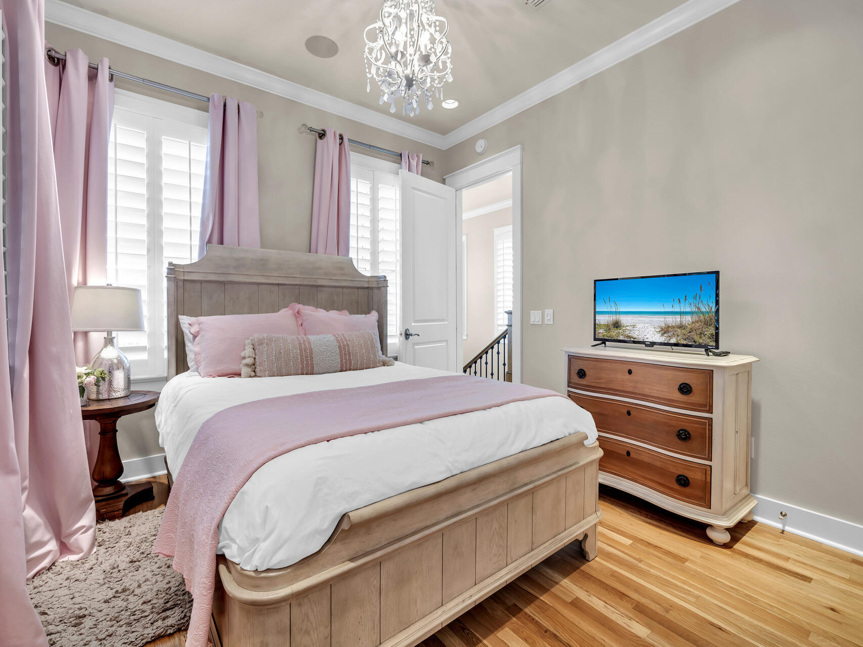 10140 East County Highway 30A, Unit 1 Inlet Beach, FL 32461 - Photo 42 of 54 a bedroom with a bed and a chandelier