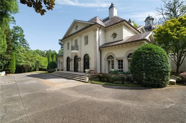 a view of a workspace with furniture and a large window