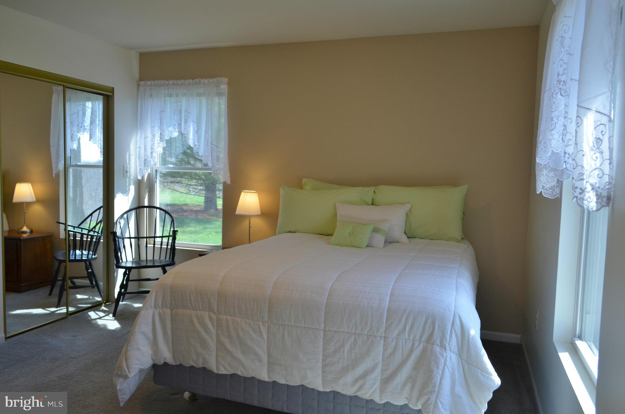 75 Fairhaven Road Tracys Landing, MD 20779 - Photo 11 of 30 a bedroom with a bed a table and windows