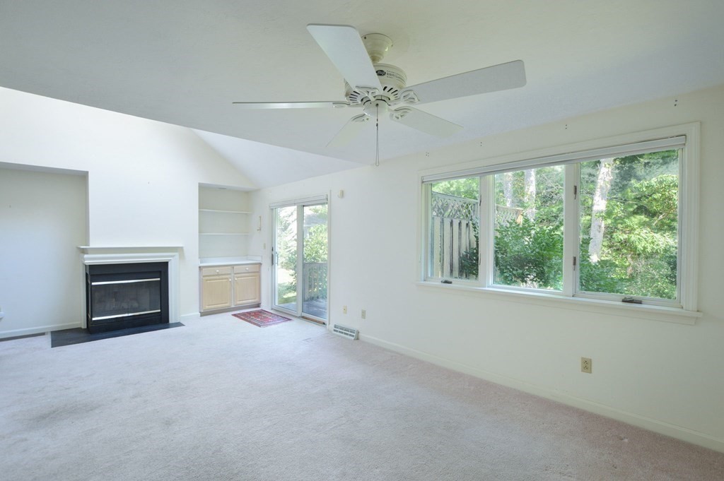 3 Kettle Lane, Unit 3 Mashpee, MA 02649 - Photo 11 of 30 an empty room with fireplace fan and windows