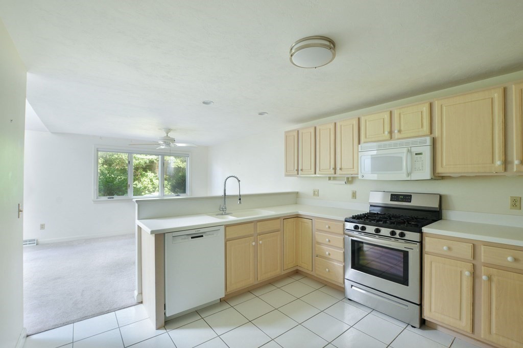 3 Kettle Lane, Unit 3 Mashpee, MA 02649 - Photo 15 of 30 a kitchen with a stove sink and cabinets