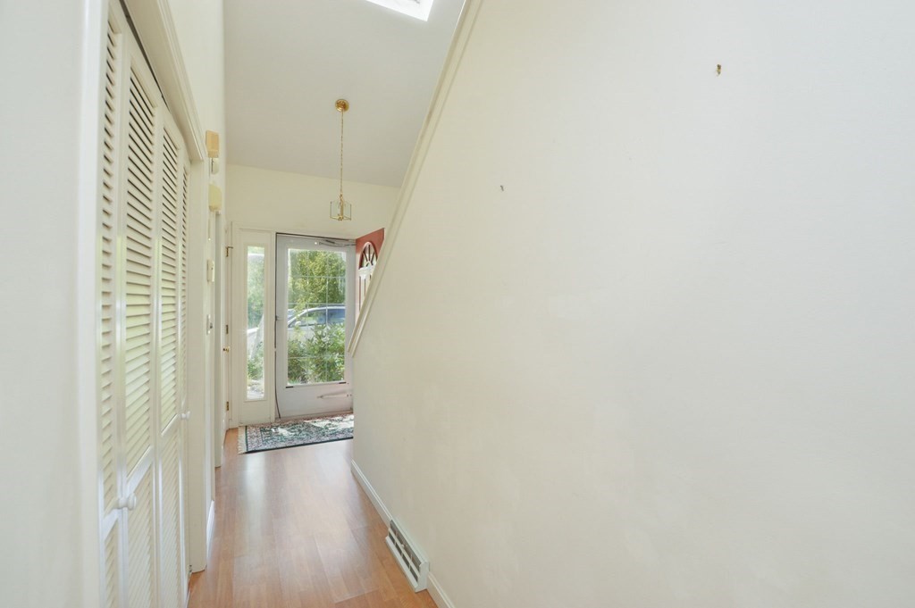 3 Kettle Lane, Unit 3 Mashpee, MA 02649 - Photo 19 of 30 a view of a hallway with wooden floor and a bathroom