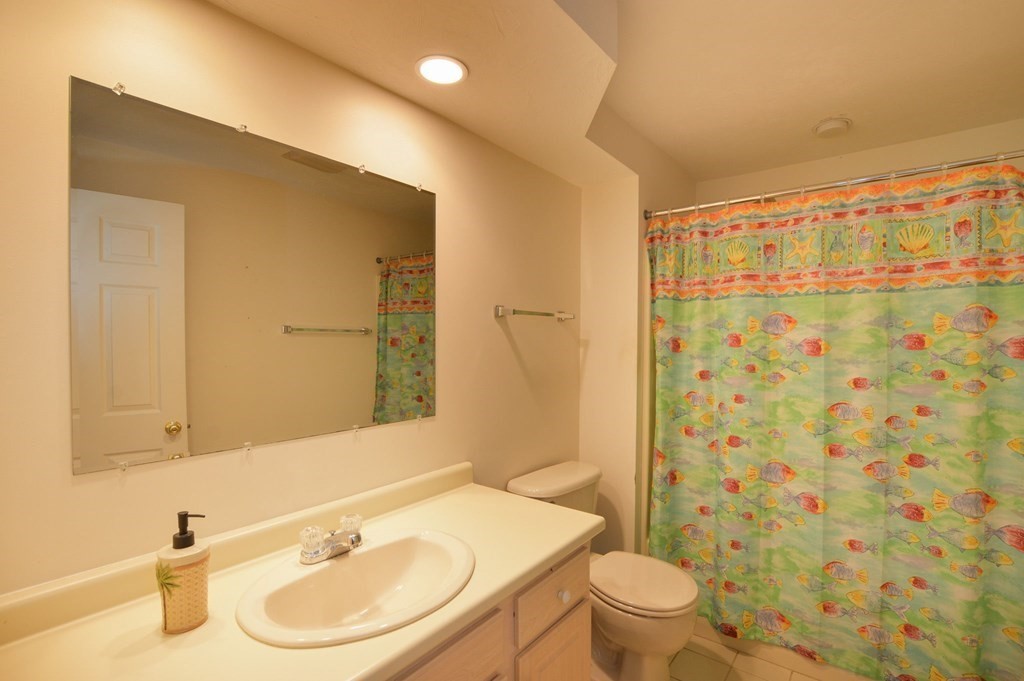 3 Kettle Lane, Unit 3 Mashpee, MA 02649 - Photo 24 of 30 a bathroom with a sink a toilet and shower curtain