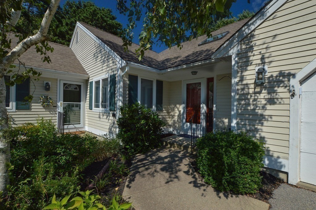 3 Kettle Lane, Unit 3 Mashpee, MA 02649 - Photo 26 of 30 a view of a house with brick walls and flower plants