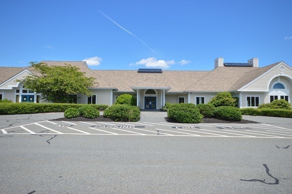 3 Kettle Lane, Unit 3 Mashpee, MA 02649 - Photo 28 of 30 a front view of a house with a yard and garage
