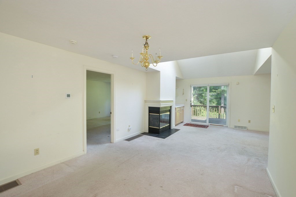 3 Kettle Lane, Unit 3 Mashpee, MA 02649 - Photo 6 of 30 a view of a livingroom with an empty space and a fireplace