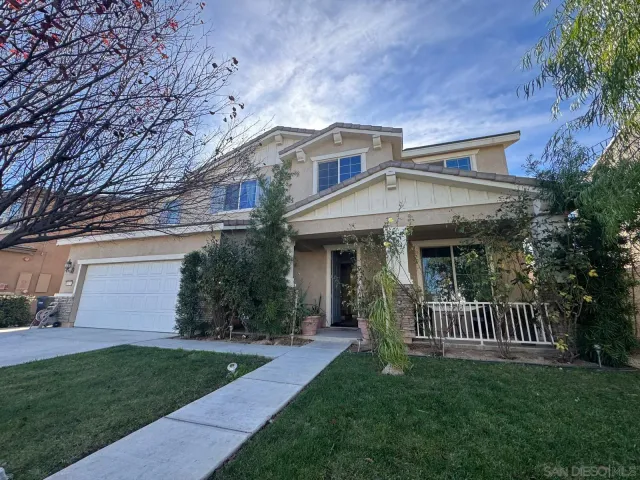 a view of a house with a yard and a garden