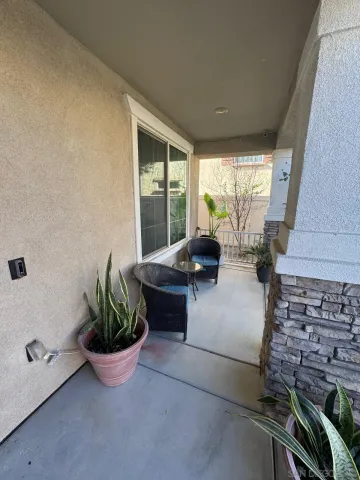 a living room with furniture and potted plant