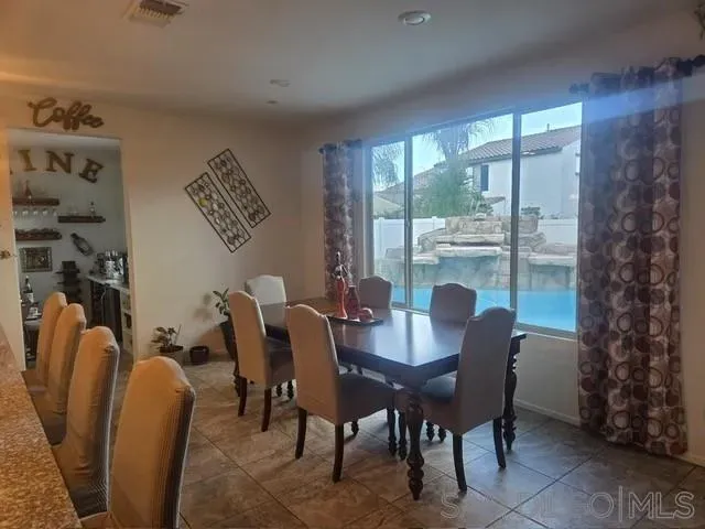 a view of a dining room with furniture window and outside view