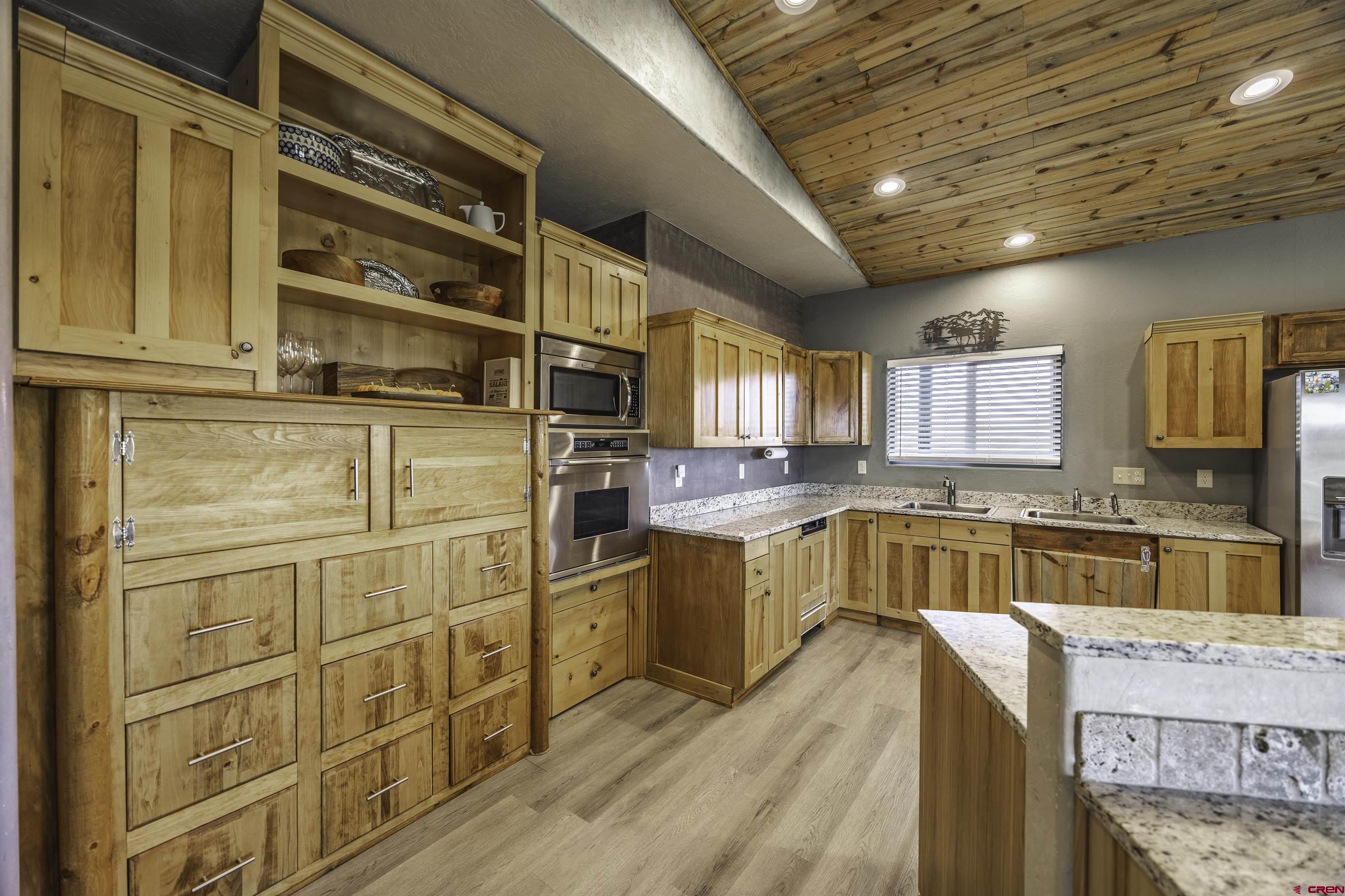 697 Grand Vista Road Delta, CO 81416 - Photo 11 of 44 a kitchen with stainless steel appliances granite countertop a sink and cabinets