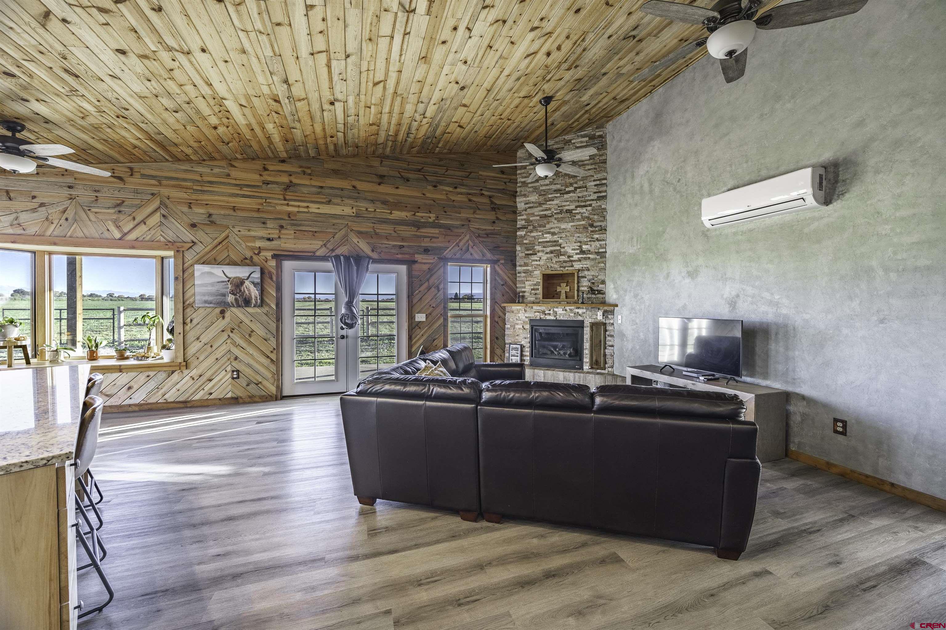 697 Grand Vista Road Delta, CO 81416 - Photo 13 of 44 a living room with furniture a large window and wooden floor