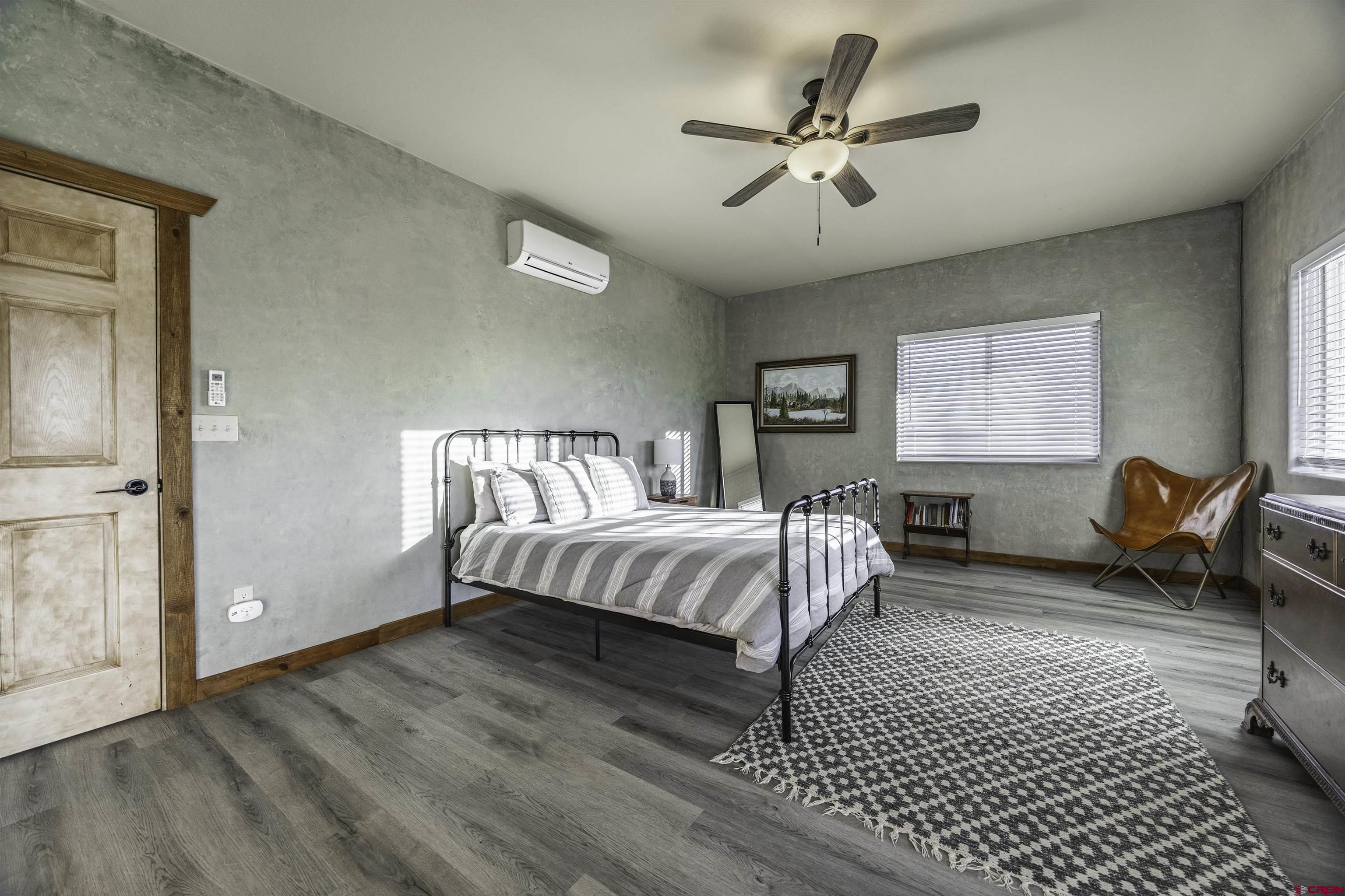 697 Grand Vista Road Delta, CO 81416 - Photo 17 of 44 a bedroom with a bed and a chandelier