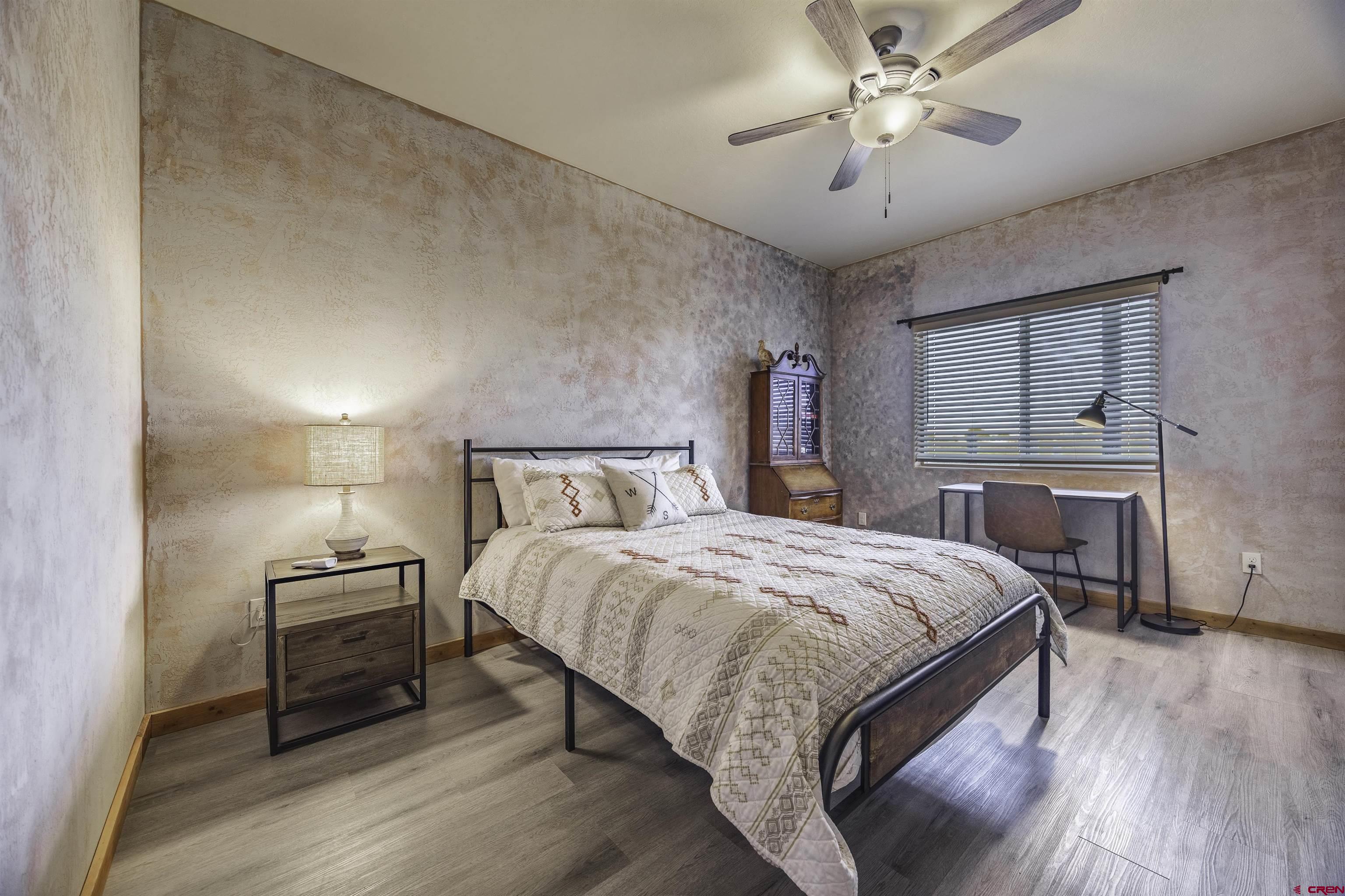 697 Grand Vista Road Delta, CO 81416 - Photo 25 of 44 a bedroom with a bed and a chandelier