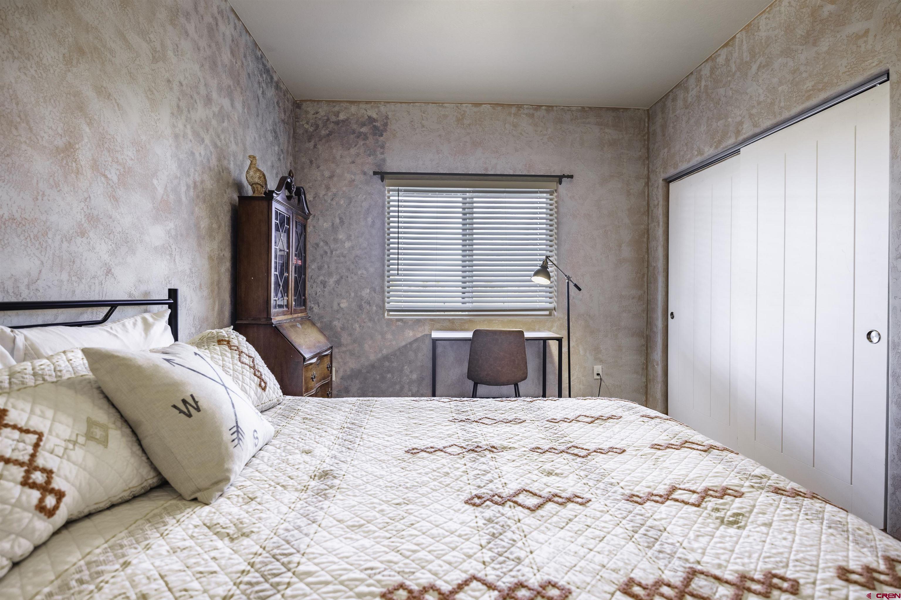 697 Grand Vista Road Delta, CO 81416 - Photo 26 of 44 a bedroom with a large bed and a dresser