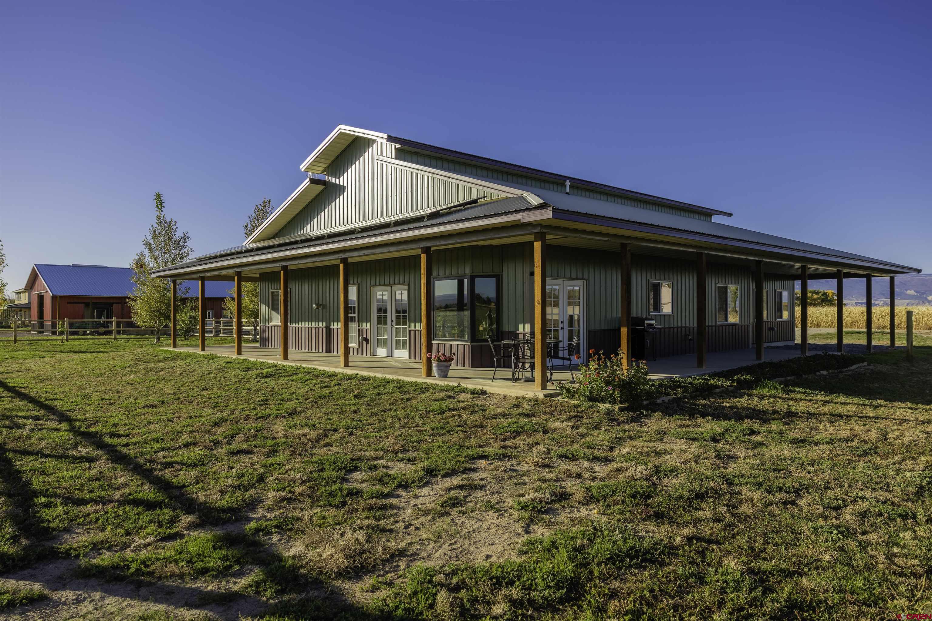 697 Grand Vista Road Delta, CO 81416 - Photo 6 of 44 a front view of a house with garden