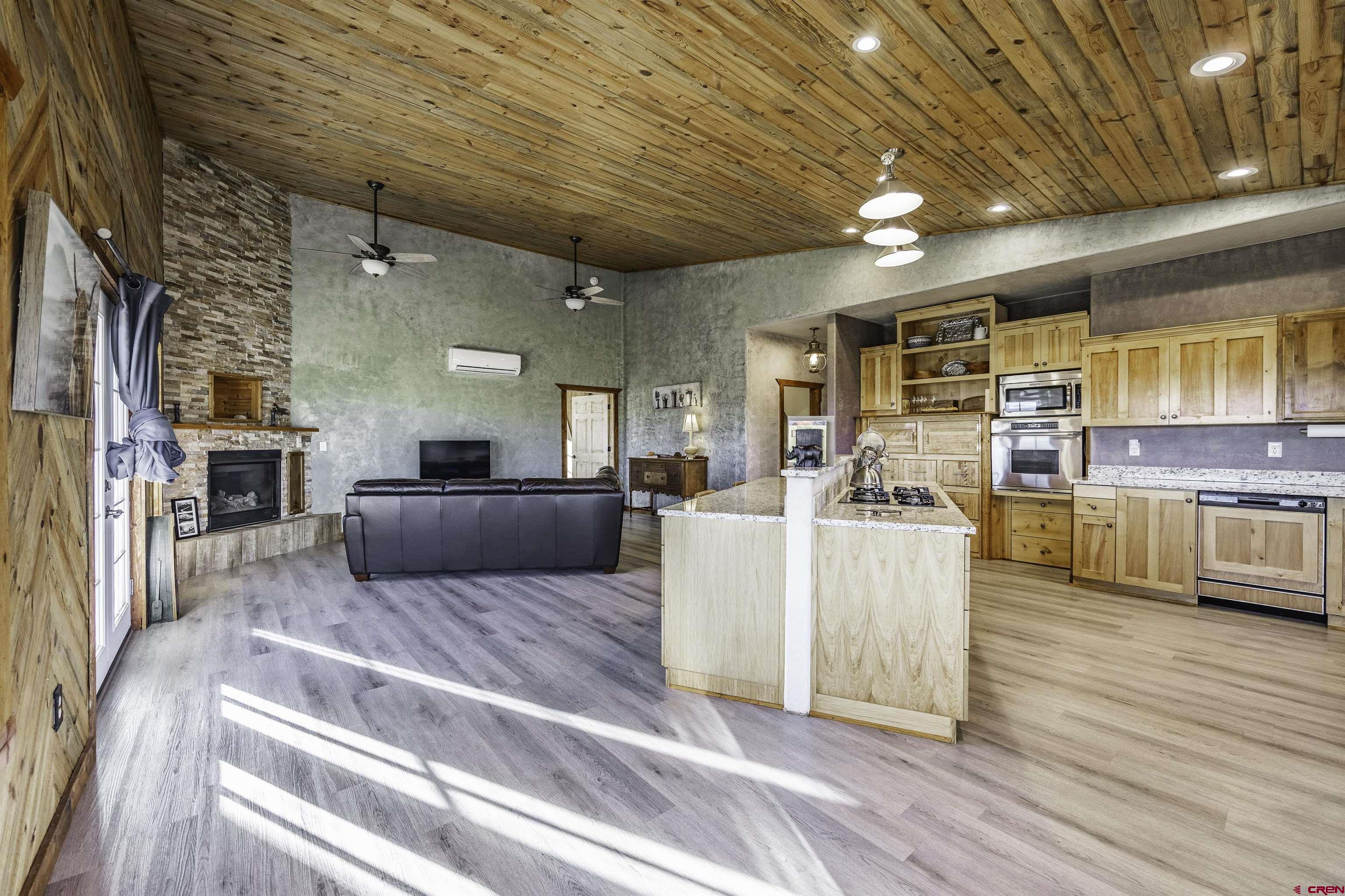 697 Grand Vista Road Delta, CO 81416 - Photo 8 of 44 a living room with furniture kitchen view and a wooden floor