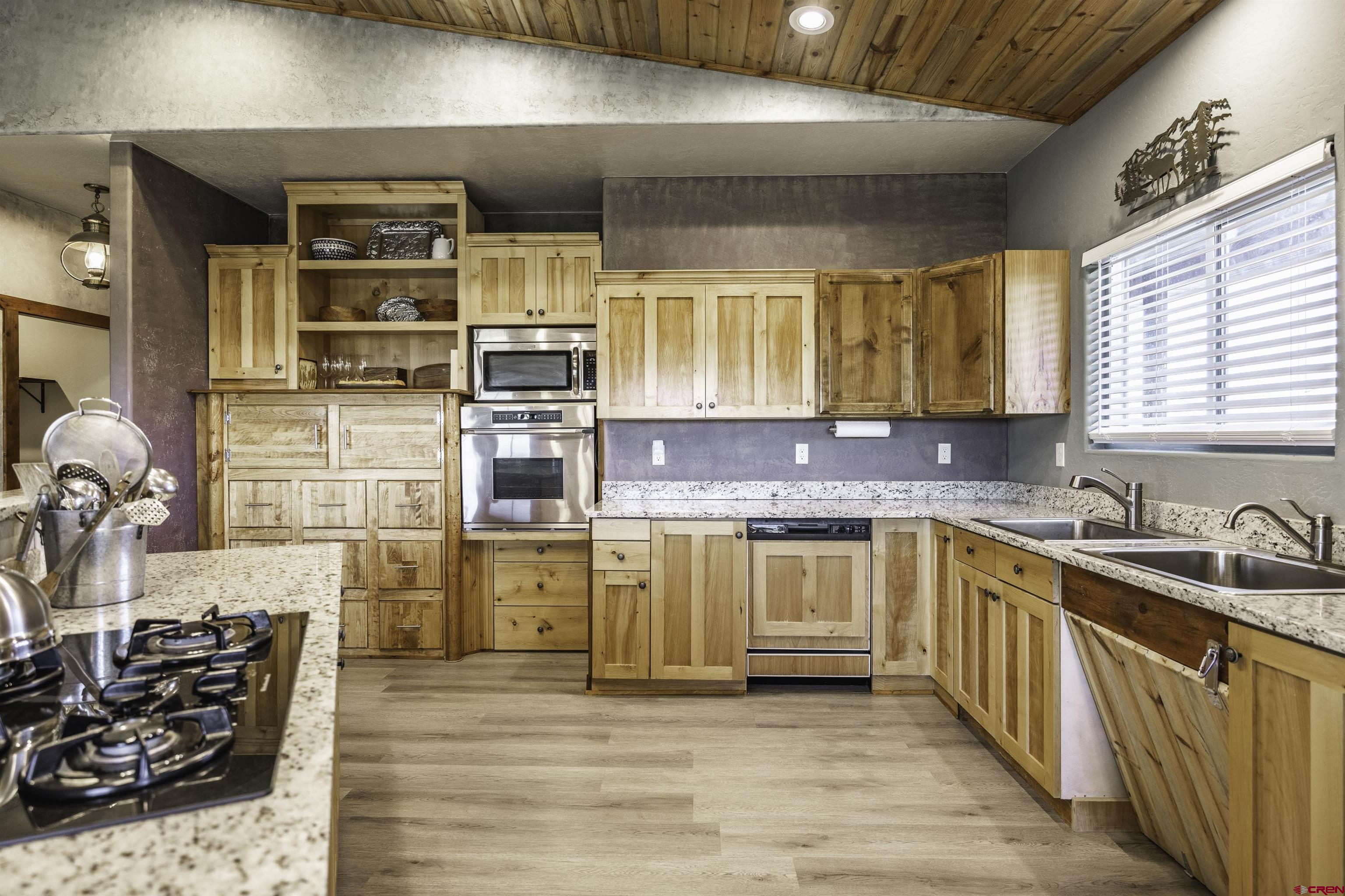 697 Grand Vista Road Delta, CO 81416 - Photo 9 of 44 a kitchen with stainless steel appliances granite countertop a sink and cabinets