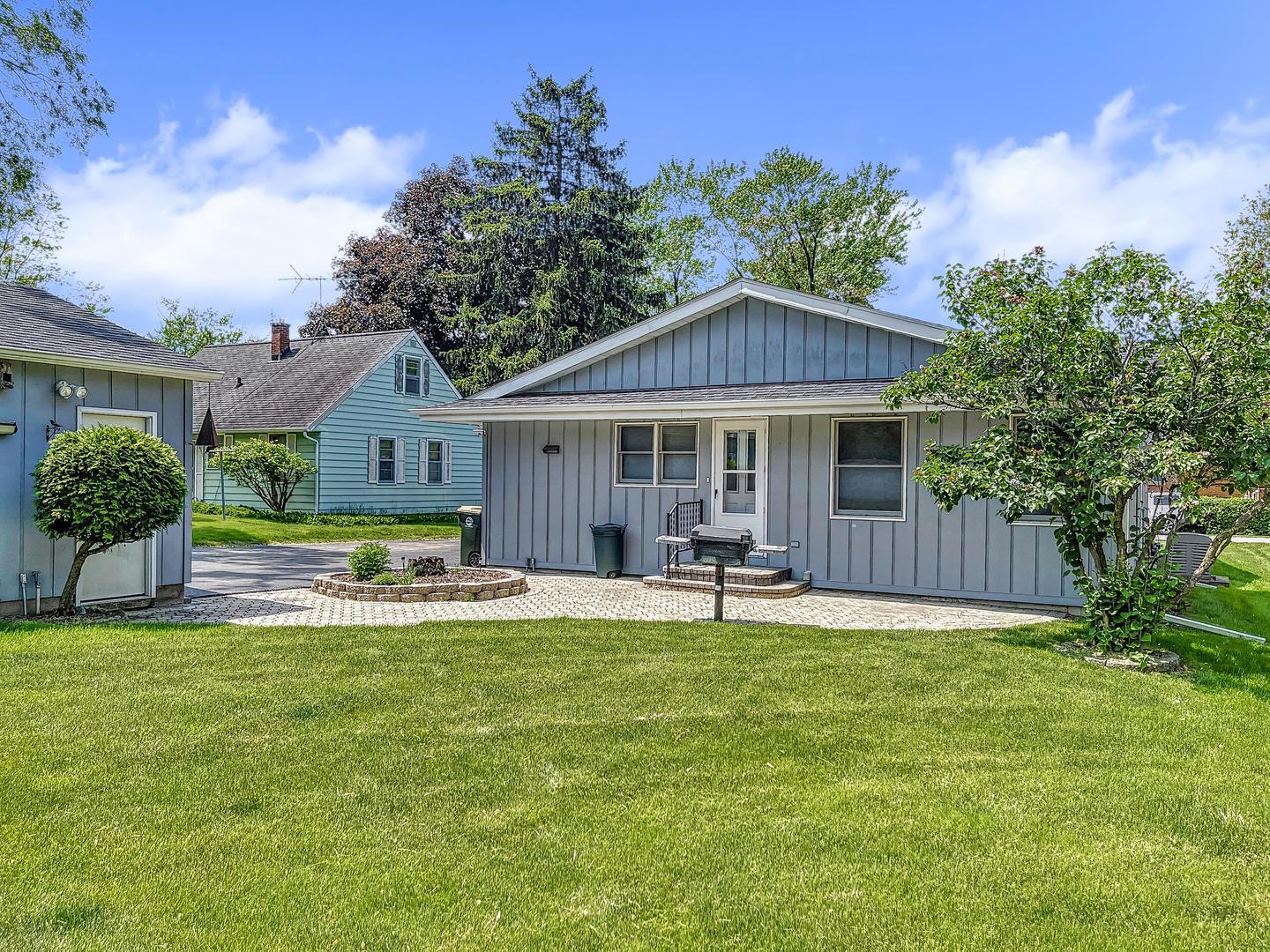 a view of a house with a yard and sitting area