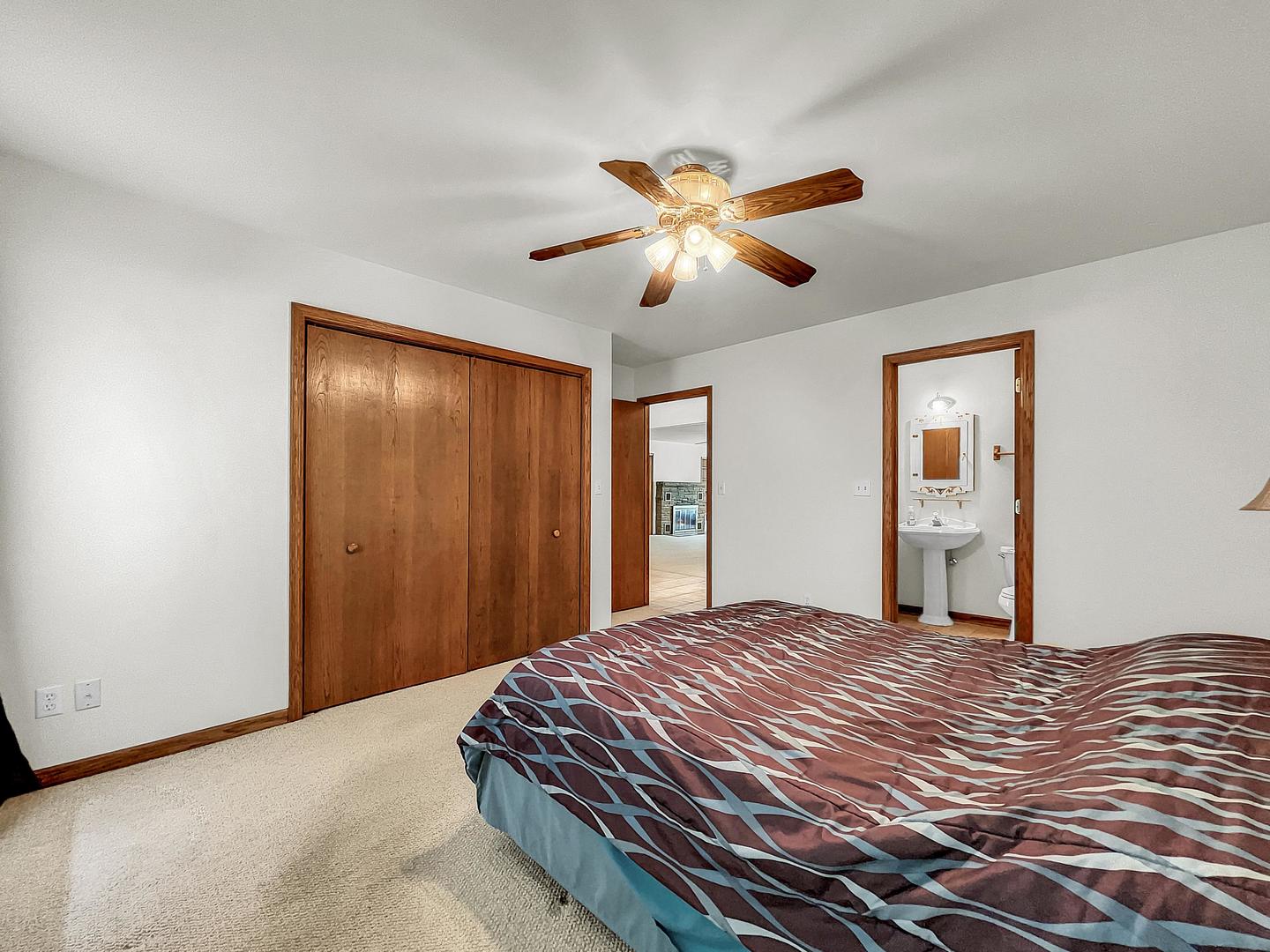 841 Rinear Road Antioch, IL 60002 - Photo 12 of 20 a bedroom with a large bed and a chandelier