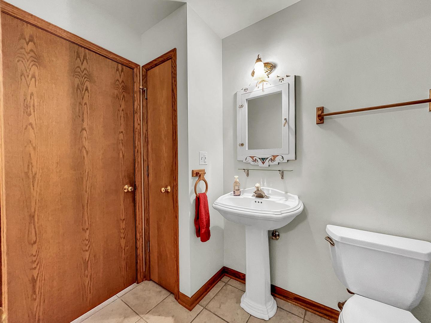 841 Rinear Road Antioch, IL 60002 - Photo 13 of 20 a bathroom with a sink toilet and a mirror