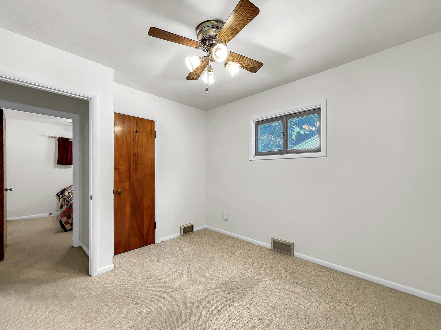 841 Rinear Road Antioch, IL 60002 - Photo 17 of 20 an empty room with closet and a chandelier fan