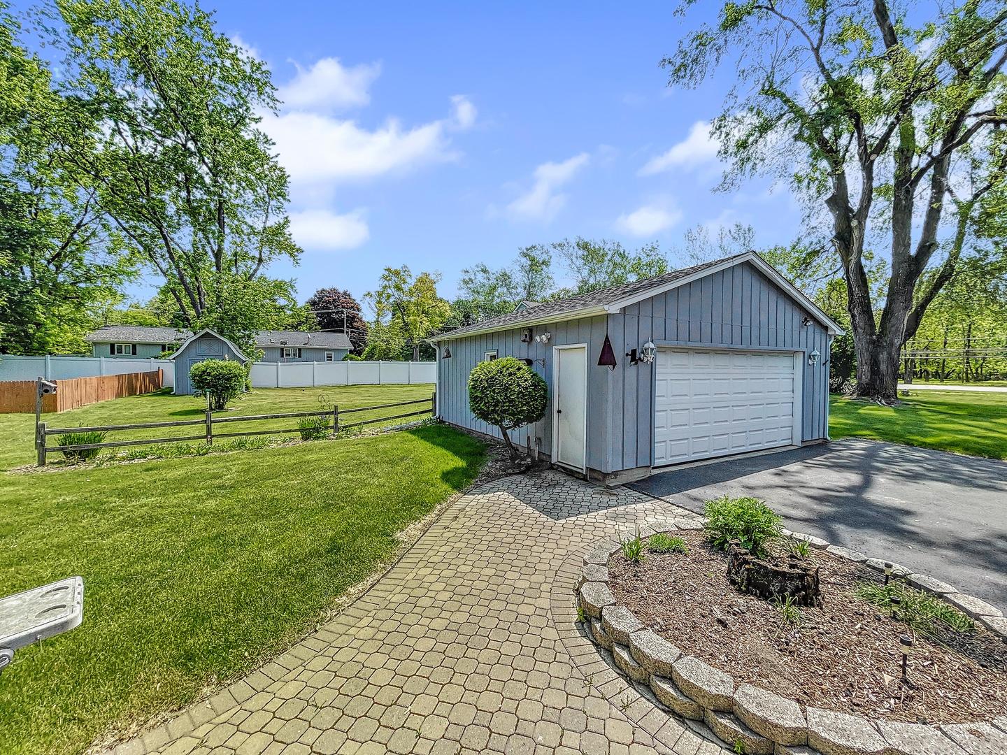 841 Rinear Road Antioch, IL 60002 - Photo 4 of 20 a view of a back yard with flower plants and wooden fence