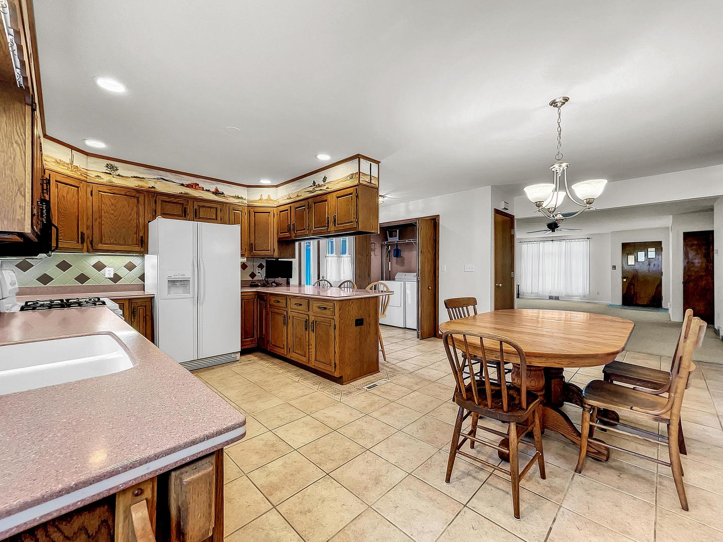 841 Rinear Road Antioch, IL 60002 - Photo 5 of 20 a kitchen with stainless steel appliances kitchen island granite countertop a table chairs and a refrigerator