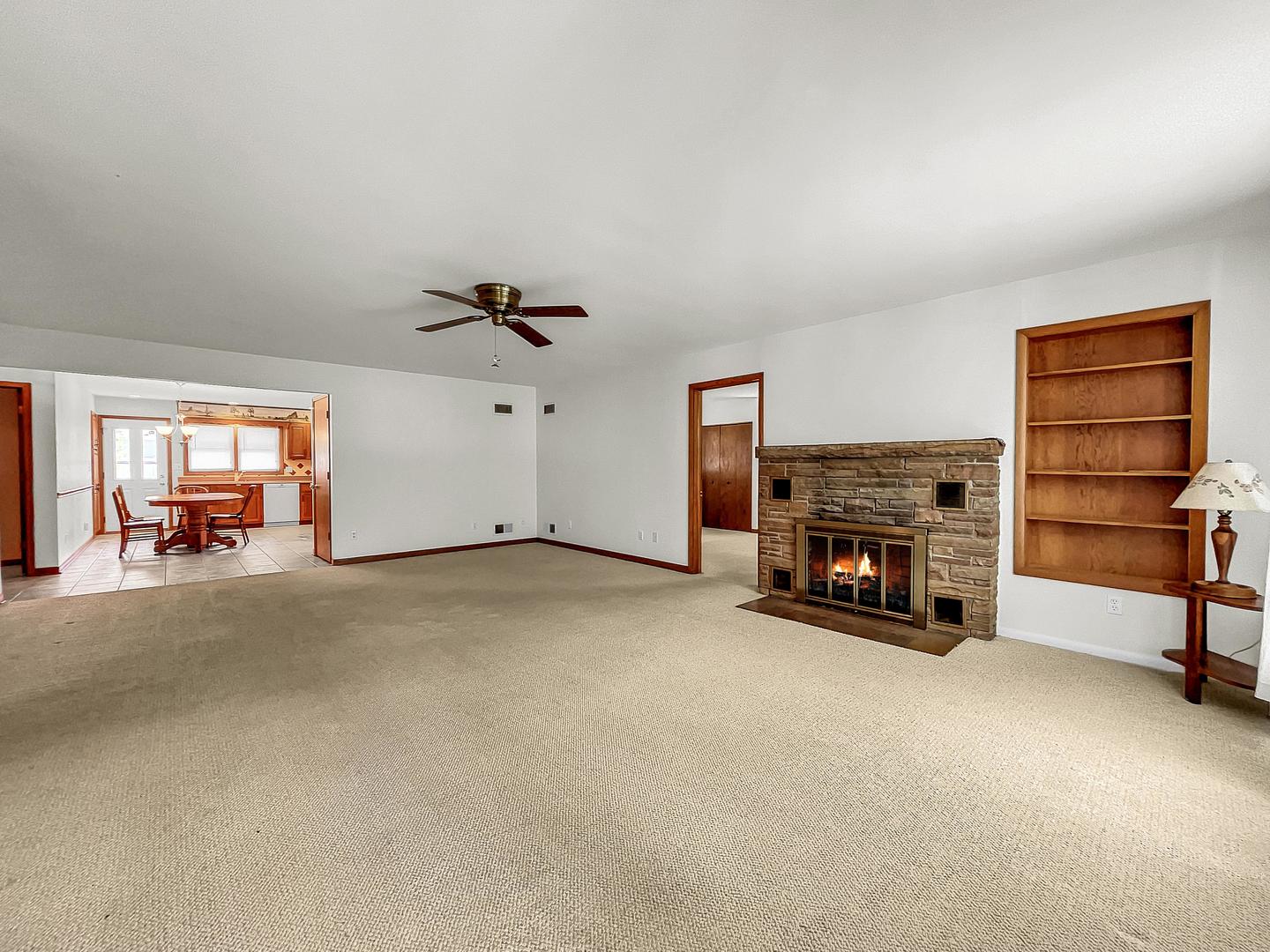 841 Rinear Road Antioch, IL 60002 - Photo 7 of 20 a view of a livingroom with a fireplace a ceiling fan and a couch