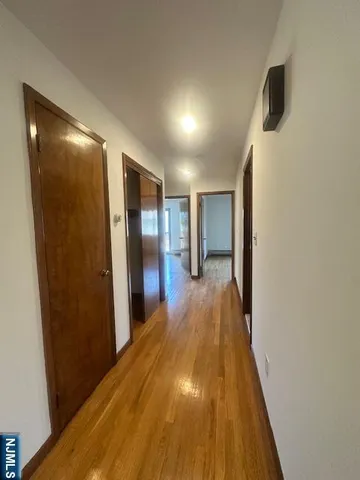 a view of hallway with wooden floor