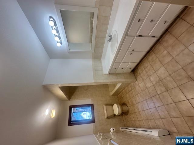 124 Johnson Avenue, Unit 2 Wallington, NJ 07057 - Photo 16 of 17 a bathroom with a sink a toilet and mirror