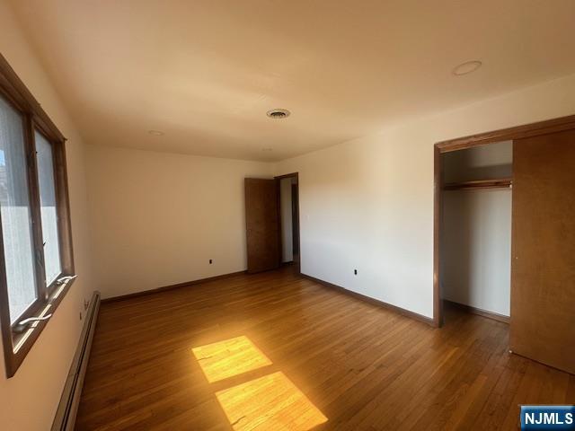 124 Johnson Avenue, Unit 2 Wallington, NJ 07057 - Photo 17 of 17 a view of an empty room with wooden floor and a window