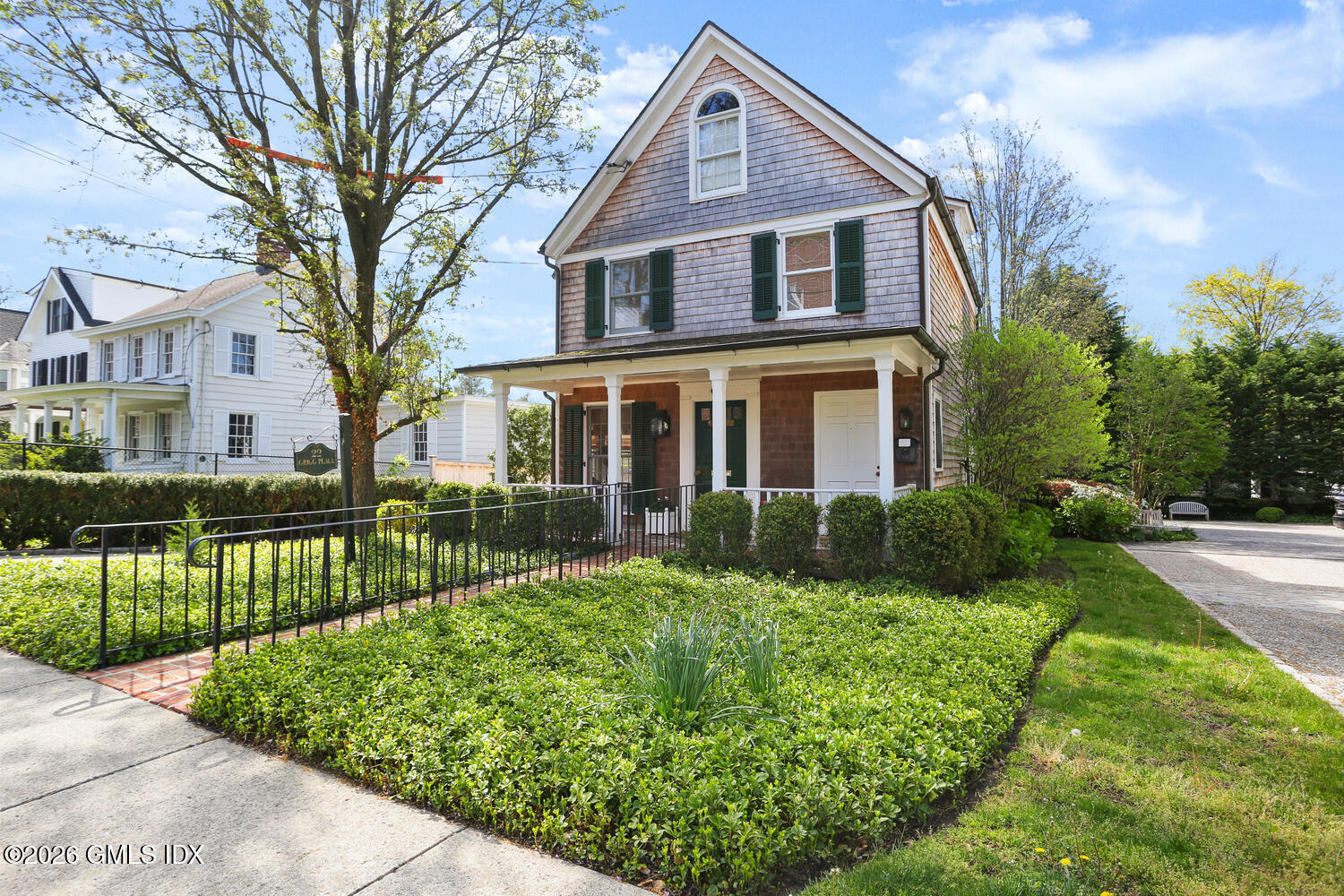 22 Grigg Street, Unit 2 Greenwich, CT 06830 - Photo 2 of 11 a front view of a house with a yard