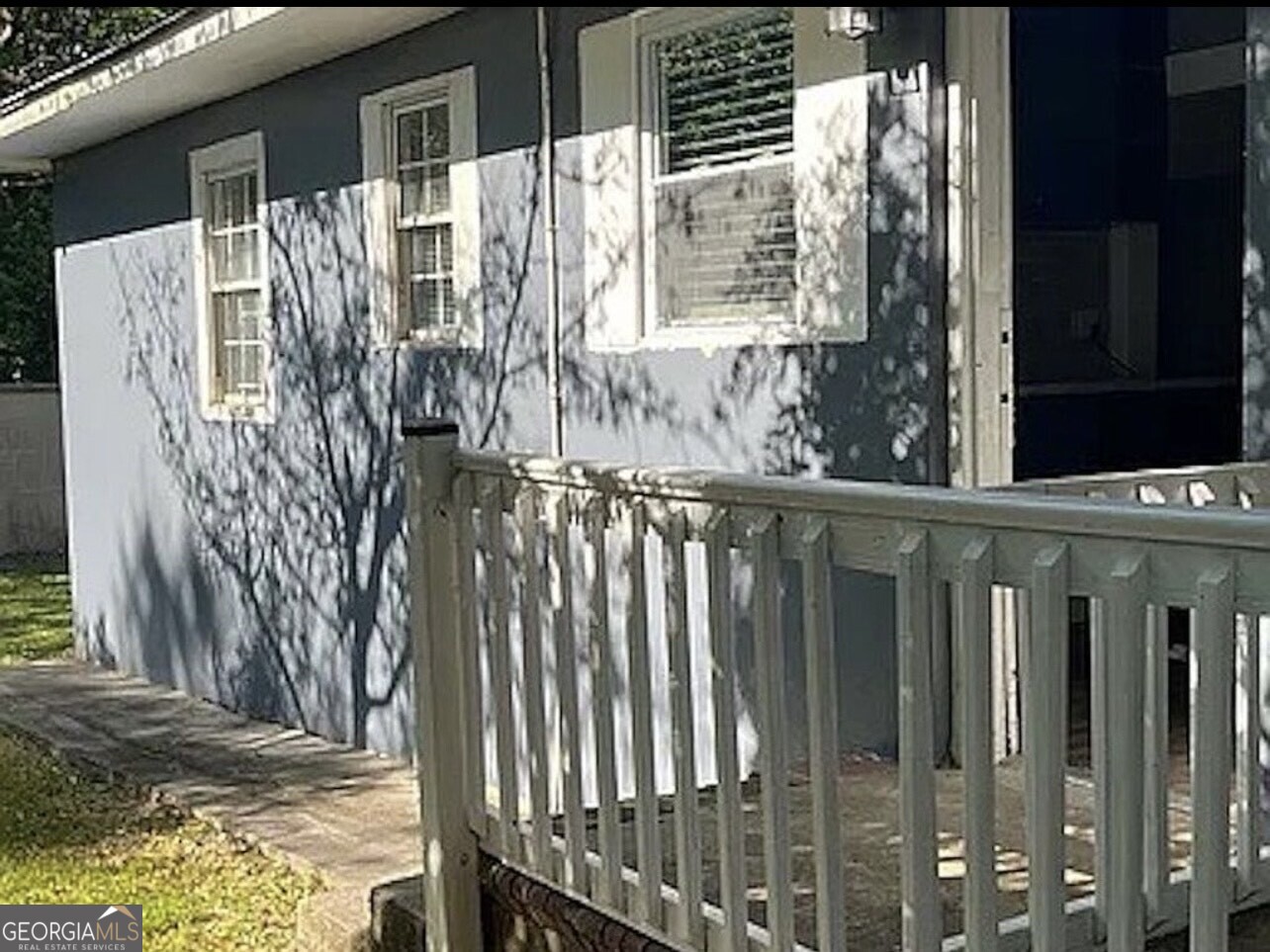 361 Woolfolk Street Macon, GA 31217 - Photo 3 of 7 a view of a wooden door with a tree