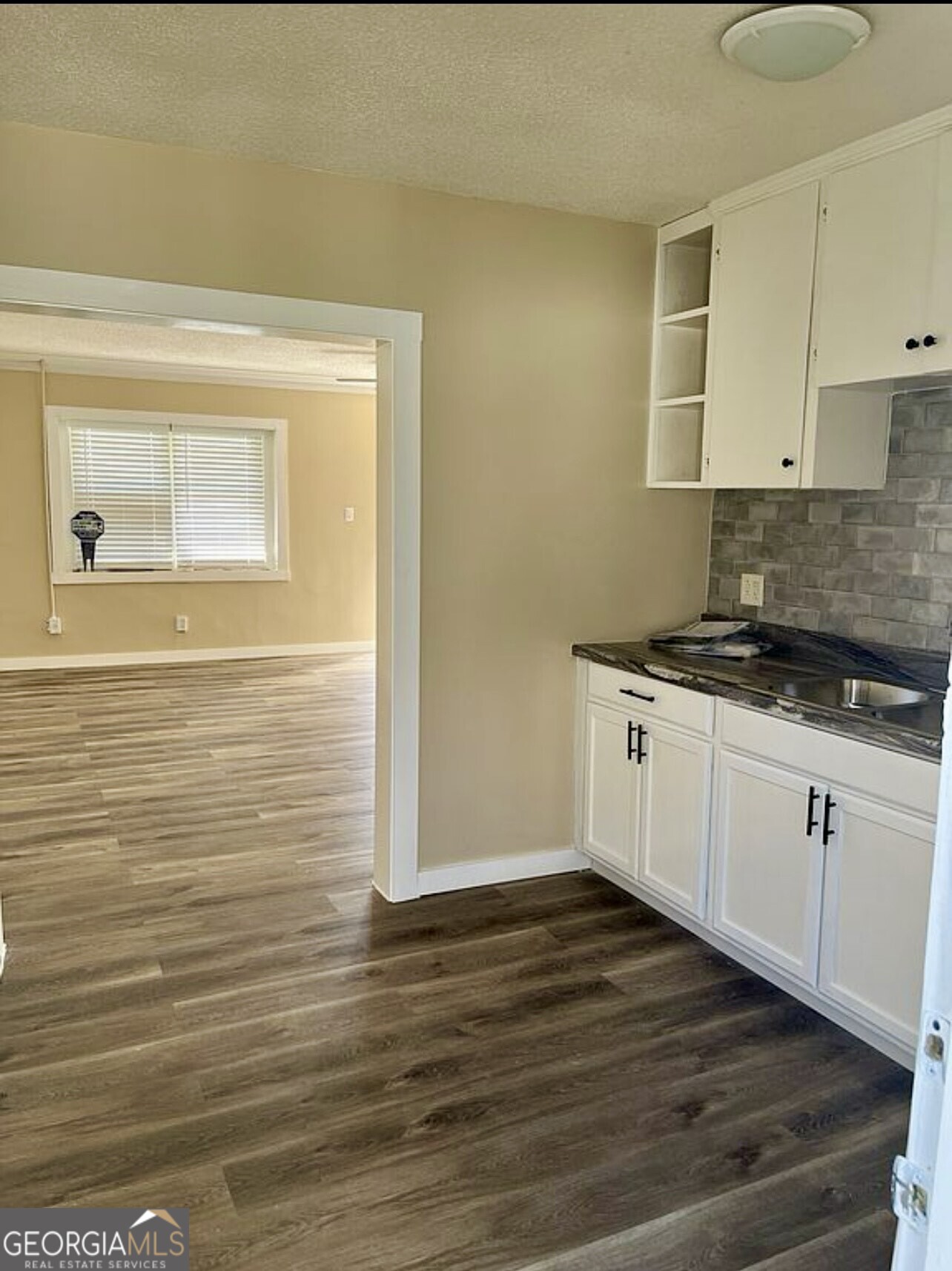 361 Woolfolk Street Macon, GA 31217 - Photo 4 of 7 a kitchen with a sink and cabinets