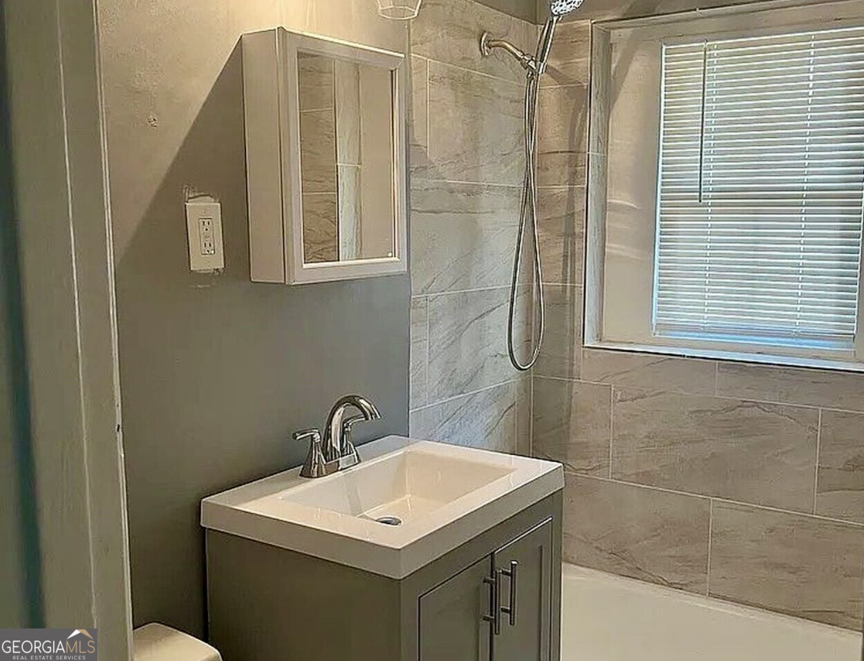 361 Woolfolk Street Macon, GA 31217 - Photo 6 of 7 a bathroom with a sink a toilet and shower