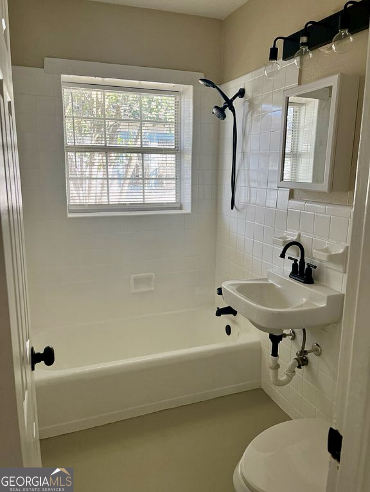 361 Woolfolk Street Macon, GA 31217 - Photo 7 of 7 a bathroom with a bath tub a toilet and a sink