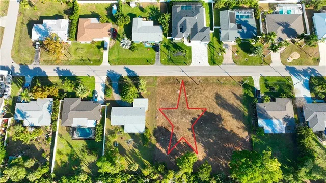 a view of backyard with swimming pool and seating space