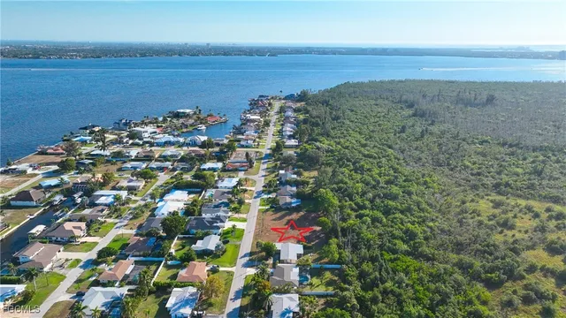 an aerial view of a houses with yard