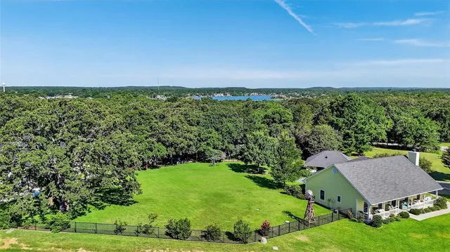 an aerial view of a house with yard