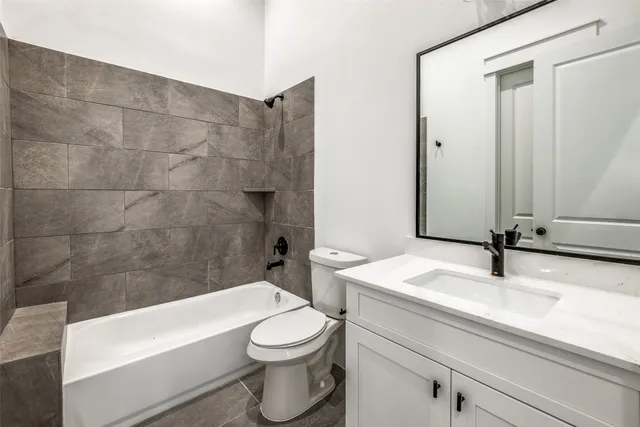 a bathroom with a sink a toilet and bathtub