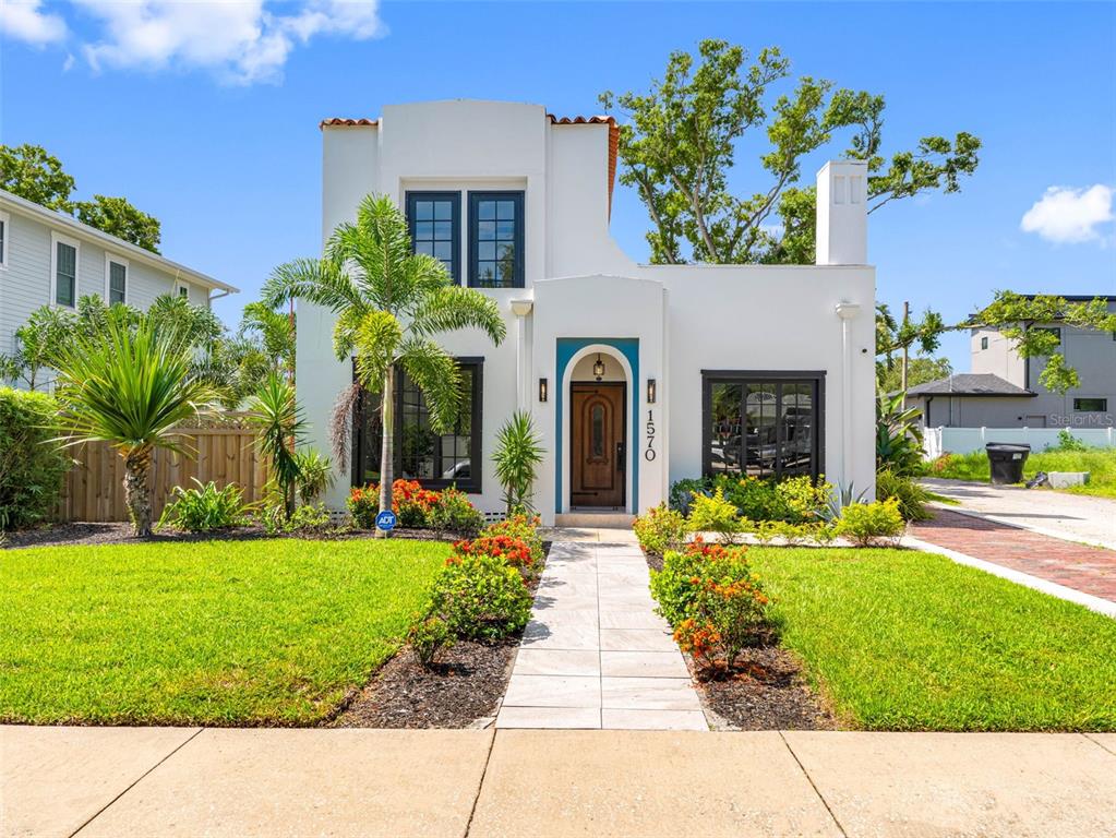 1570 48th Avenue North St. Petersburg, FL 33703 - Photo 1 of 75 a front view of a house with a garden and plants