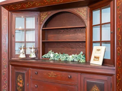 a kitchen with kitchen island granite countertop a sink a stove and a wooden floors