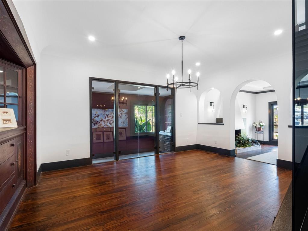 1570 48th Avenue North St. Petersburg, FL 33703 - Photo 17 of 75 an empty room with wooden floor and windows