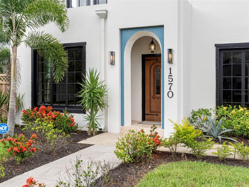 1570 48th Avenue North St. Petersburg, FL 33703 - Photo 3 of 75 a front view of yellow house with flowers