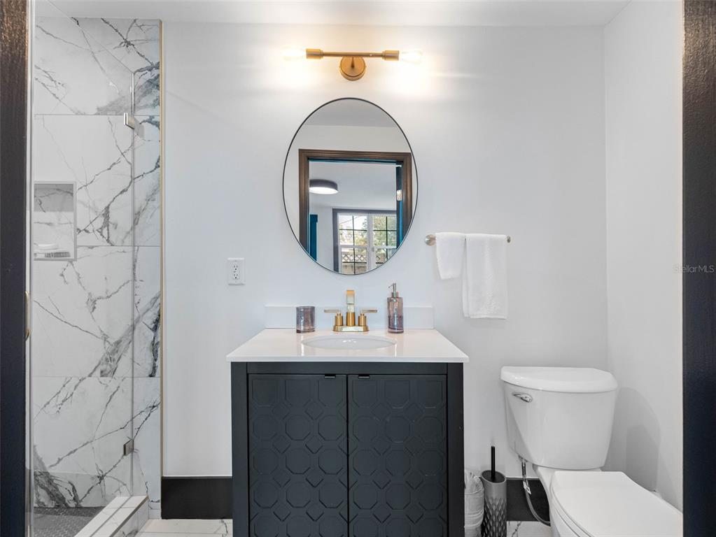 1570 48th Avenue North St. Petersburg, FL 33703 - Photo 35 of 75 a bathroom with a toilet a sink and a mirror