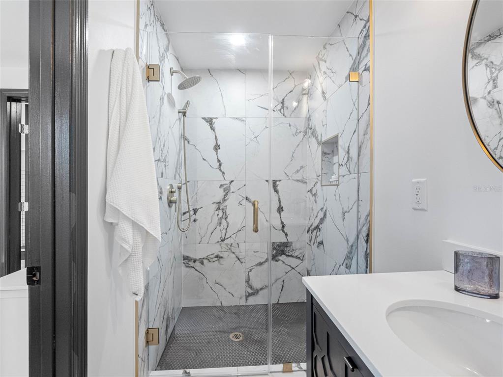 1570 48th Avenue North St. Petersburg, FL 33703 - Photo 36 of 75 a bathroom with a sink and a mirror