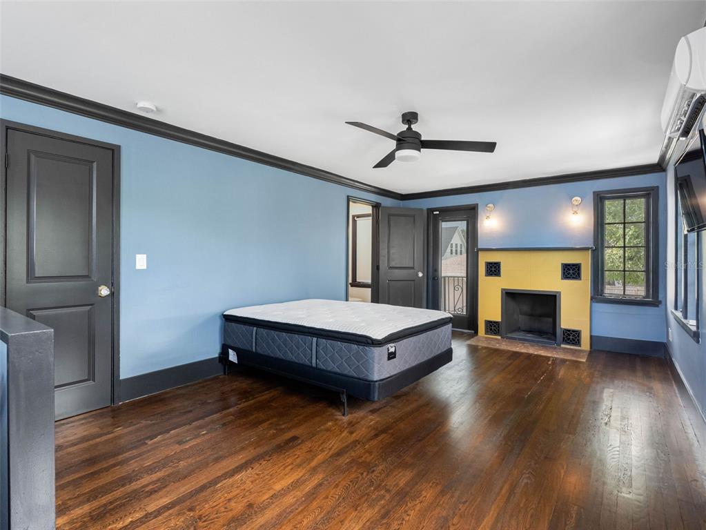 1570 48th Avenue North St. Petersburg, FL 33703 - Photo 37 of 75 a spacious bedroom with a bed and a fireplace