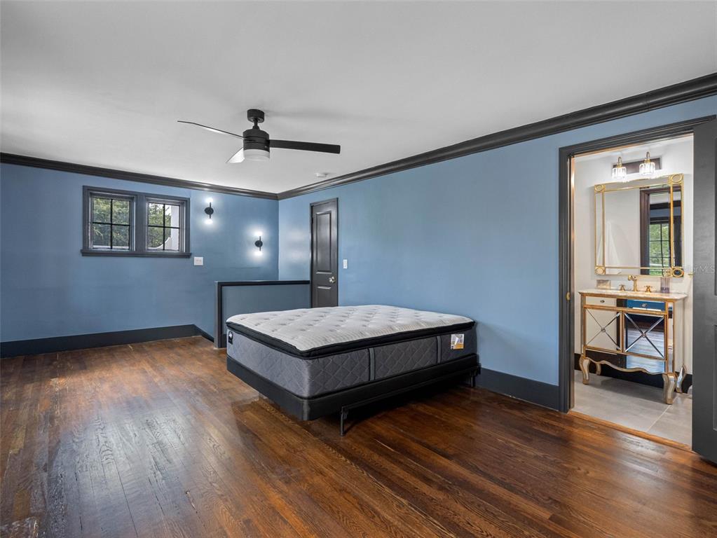 1570 48th Avenue North St. Petersburg, FL 33703 - Photo 39 of 75 a bedroom with a bed and a chandelier