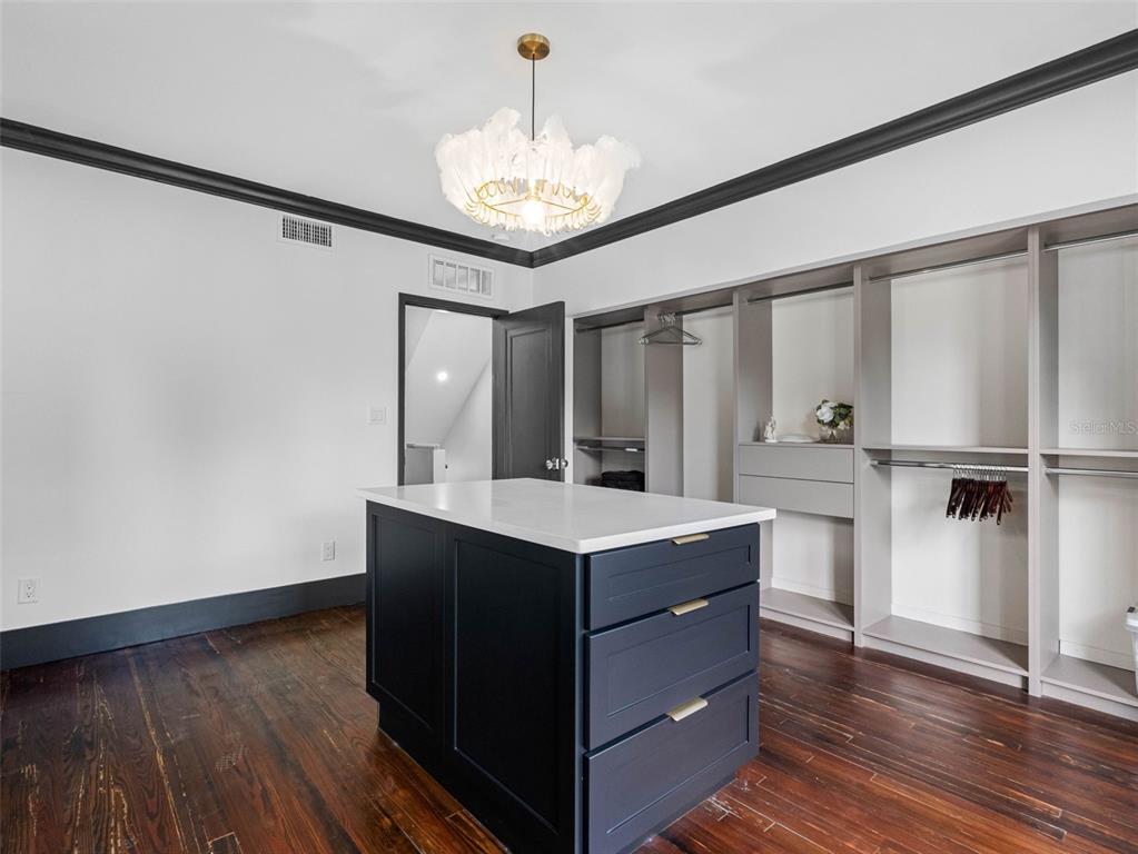 1570 48th Avenue North St. Petersburg, FL 33703 - Photo 47 of 75 a kitchen with kitchen island white cabinets and stainless steel appliances